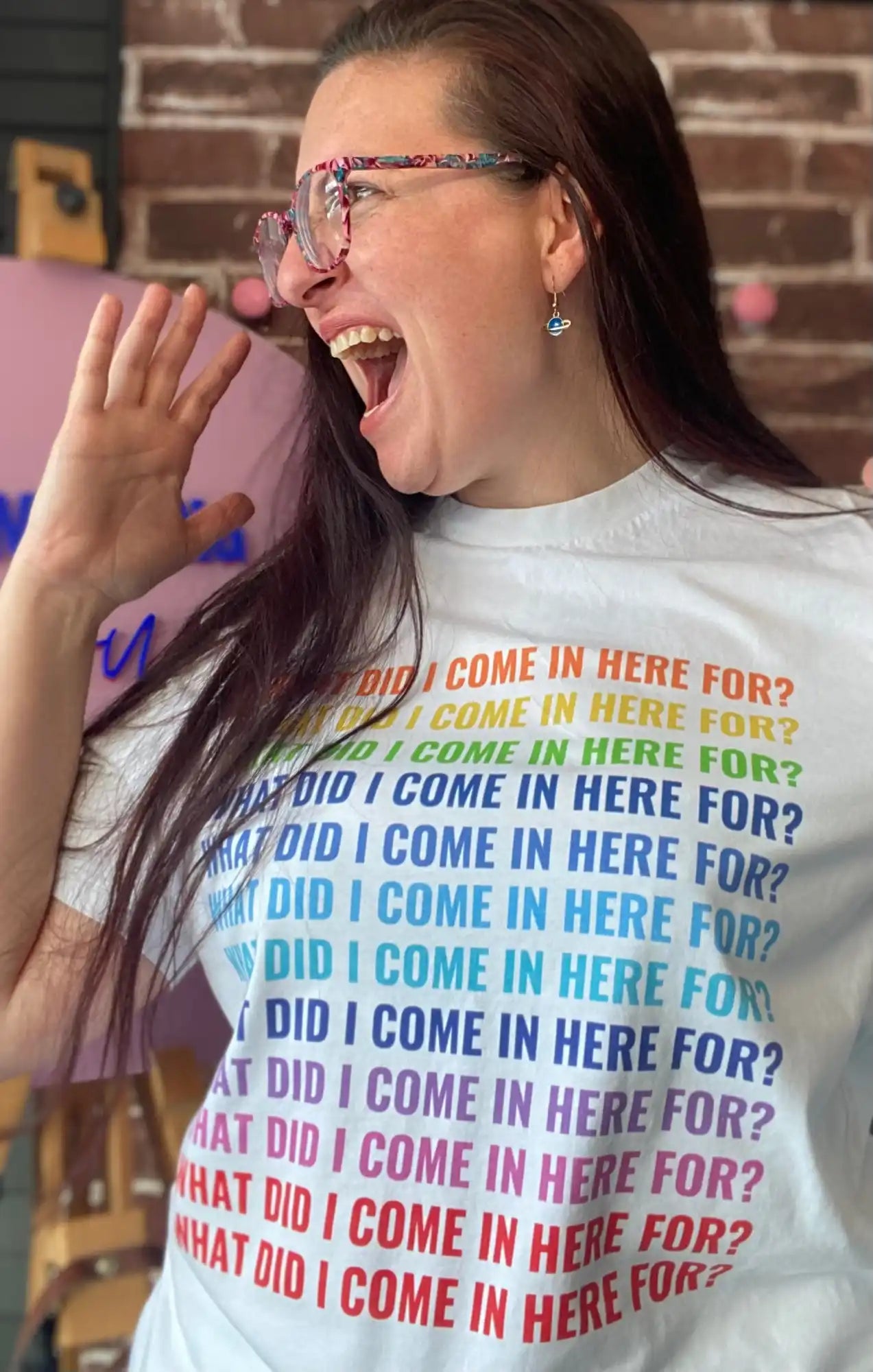 White t-shirt with rainbow text.